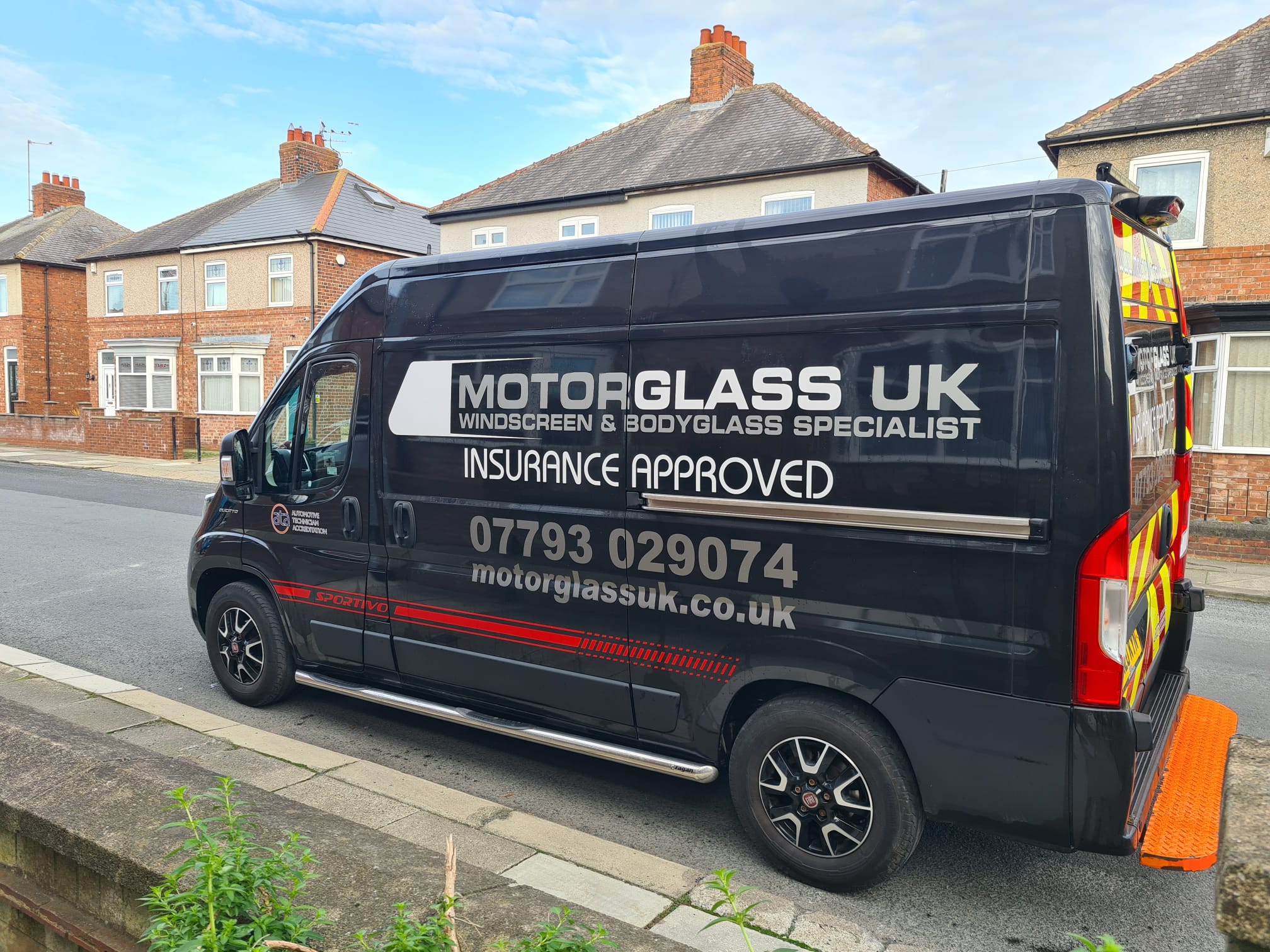 Motor Glass UK windscreen replacement vehicle. dark blue van white and grey writing